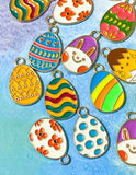 easter egg eggs gold tone metal enamel enamelled charm charms pendant spring springtime cute kawaii craft shop supplies uk bright colourful pink yellow chick bunny blue green orange teal turquoise white floral flowers striped stripes