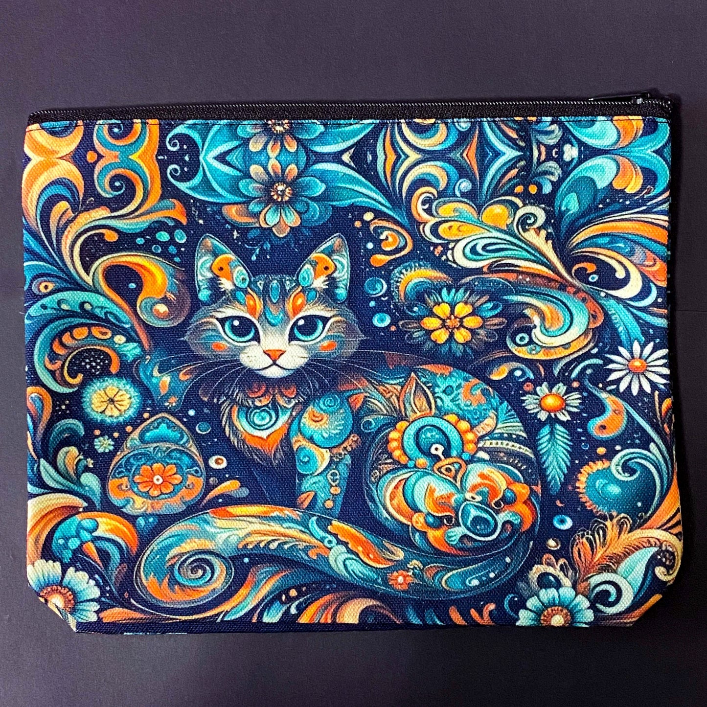decorative folk art cat zipper canvas pouch featuring bright turquoise, navy and orange swirling floral patterns on a dark blue background. uk cute magical letterbox gifts shop. journaling pouch or pencil case.