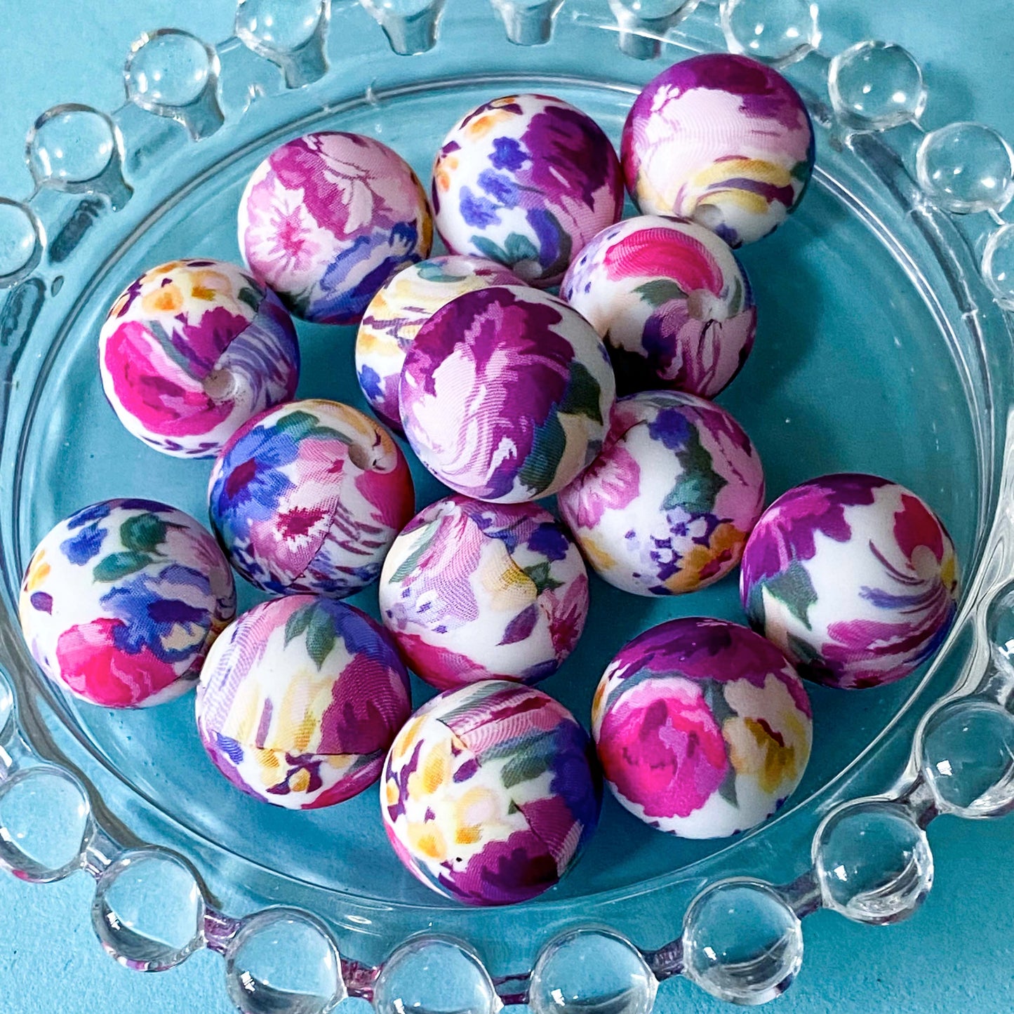 round 16mm silicone beads with a rich vibrant floral pattern in shades of magenta, purple, lilac, yellow and blue. Uk cute craft supplies shop. Materials for beaded pens and jewellery making.
