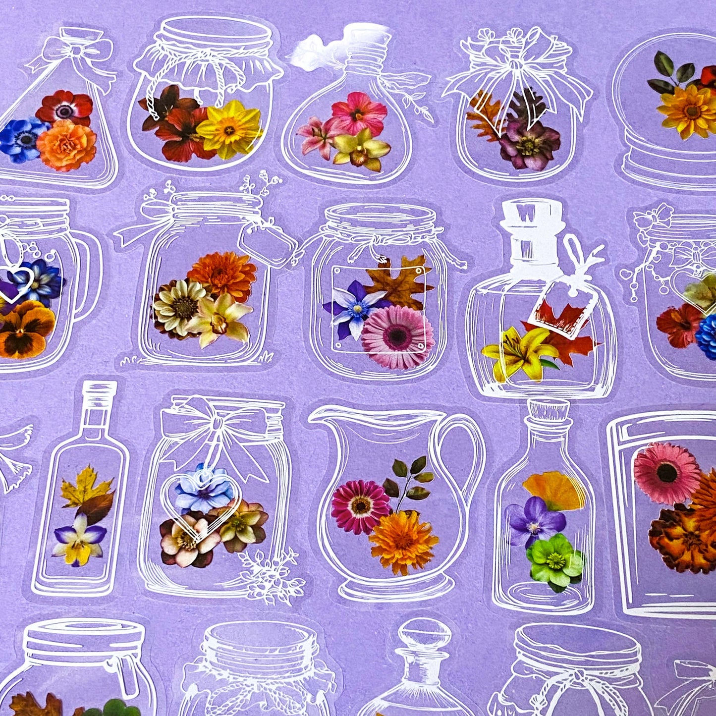 stickers in clear plastic of jars and bottles with flowers on a purple background