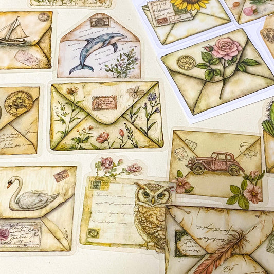 pack of 50 different vintage envelope themed decorative stickers featuring woodland animals, flowers, butterflies, birds and botanical illustrations. clear PET sticker set for journaling and scrapbooking.