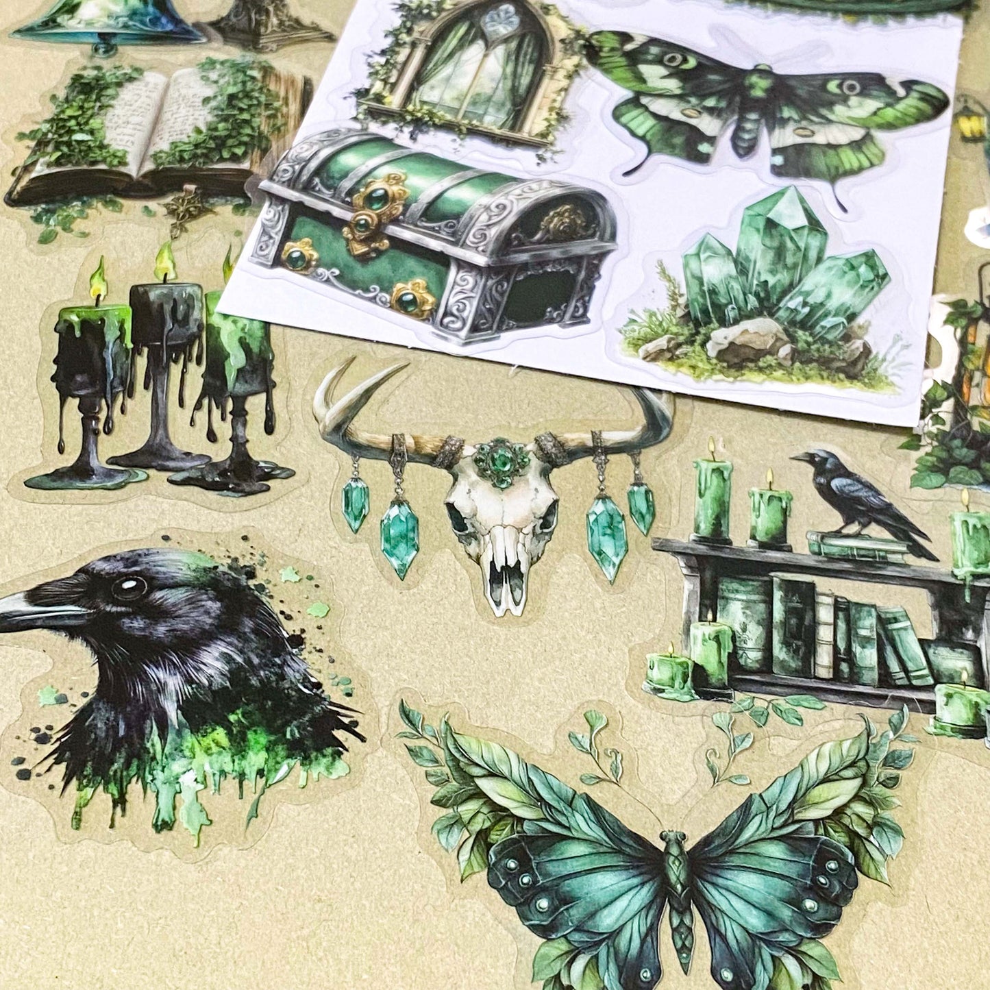 pack of 50 different emerald green magical stickers featuring witches, spell books, crystals, ravens, lanterns, enchanted moths, potion bottles and fantasy green clear PET illustrations. Uk stationery shop.