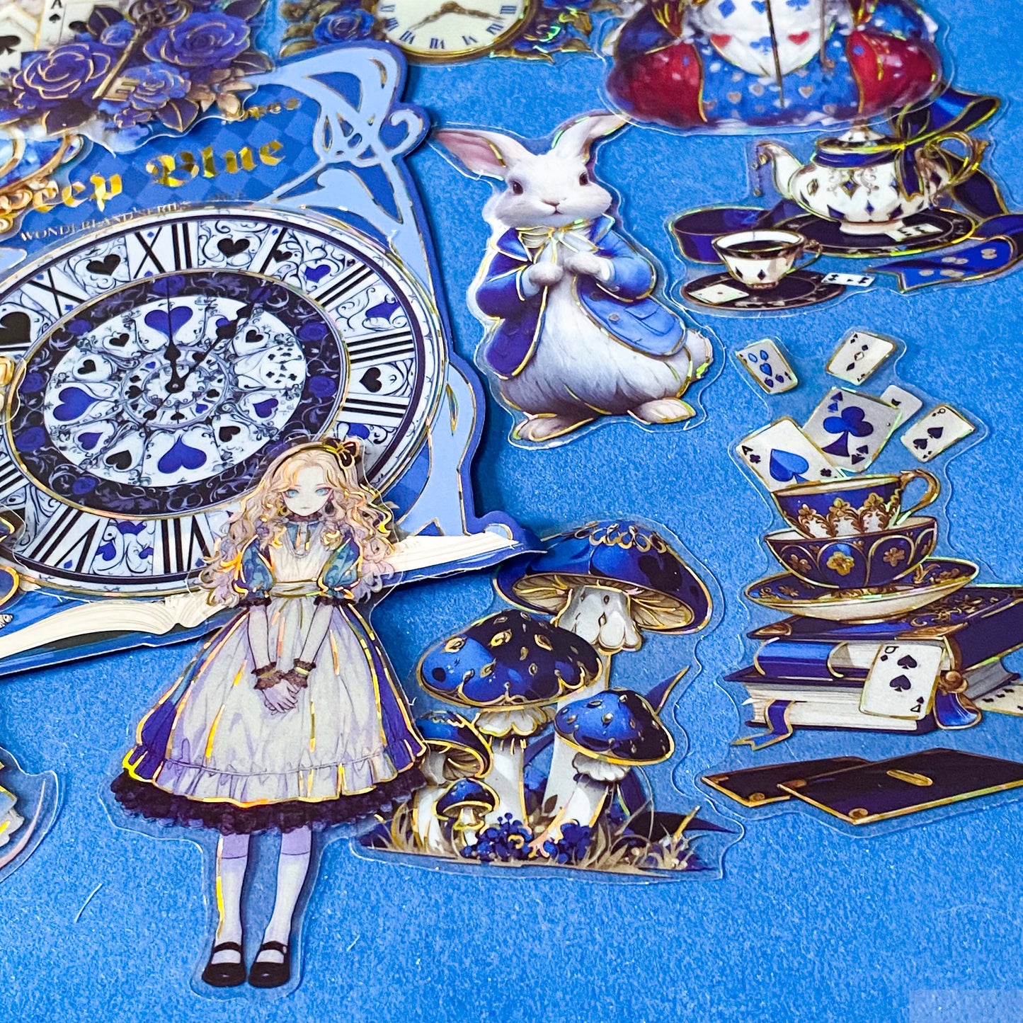 large blue alice in wonderland laser holo holographic plastic stickers featuring white rabbit, alice, clocks, teacups and fantasy illustrations