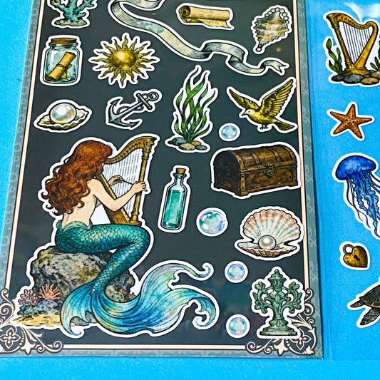 mermaid's secret cove little mermaid matte sticker pack with 2 decorative sheets featuring elegant mermaids, dolphins, whales, jellyfish, turtles, sailing ships, pearls, seashells and vintage ocean inspired illustrations Uk stationery shop.