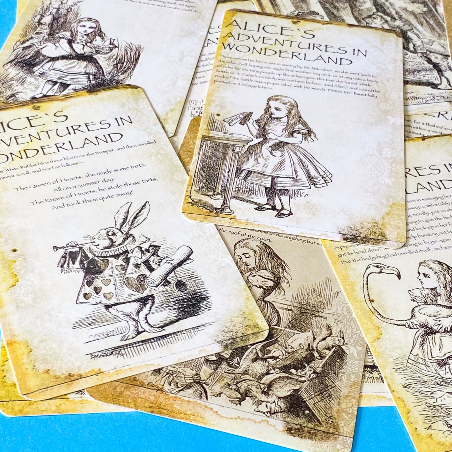 vintage alice in wonderland postcard set with aged sepia parchment illustrations, kraft belly band and wax seal presentation making a beautiful uk letterbox gift