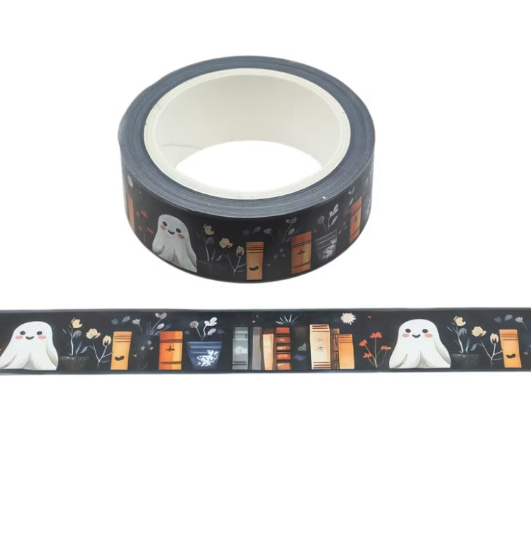 A roll of Halloween-themed washi tape with a black background, featuring cute white ghosts, orange and brown bookshelves, and small flowers, shown both on the roll and unrolled.