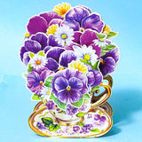 vintage teacup with purple pansies and white daisies 3d pop up card on a blue background