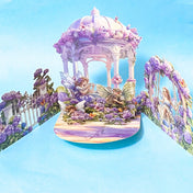 Fantasy garden lilac floral pop up card with fairies and flowers on a blue background