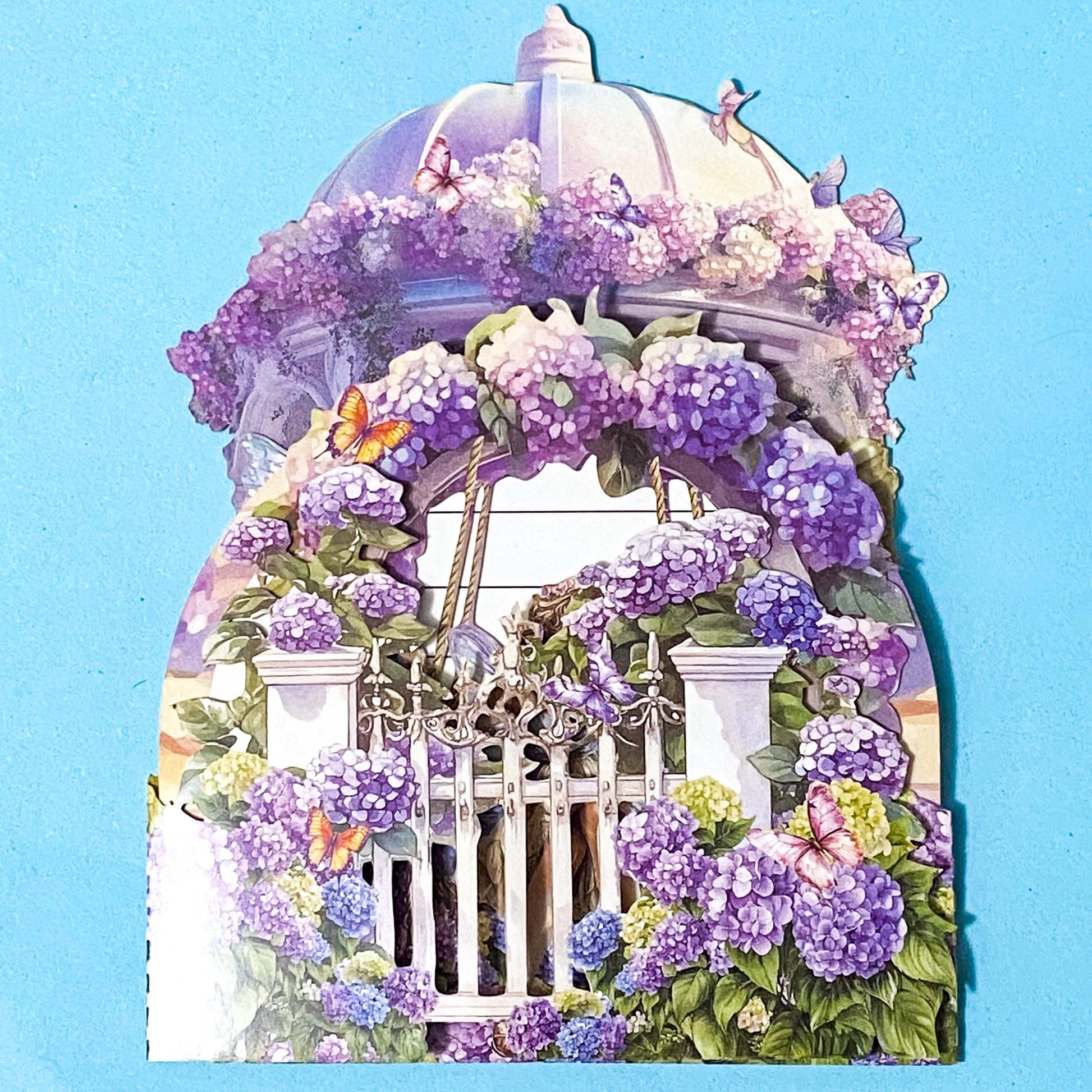 Decorative pop up 3d  card with a floral design featuring purple flowers and butterflies on a blue background