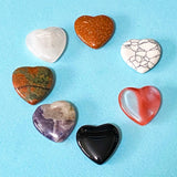 set of heart shaped carved gemstones on a blue background