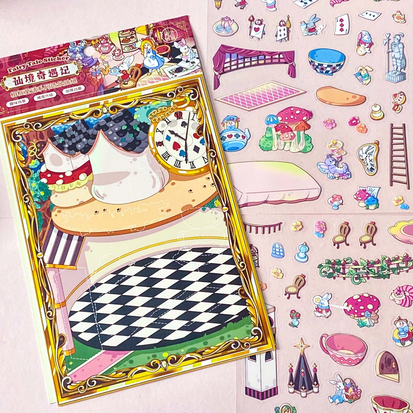 alice in wonderland sticker scene set with background card sheet and clear decorative stickers including teacup, playing cards and fantasy objects. activity creative set