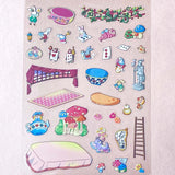 alice in wonderland sticker scene set with background card sheet and clear decorative stickers including teacup, playing cards and fantasy objects. activity creative set