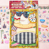 alice in wonderland sticker scene set with background card sheet and clear decorative stickers including teacup, playing cards and fantasy objects. activity creative set