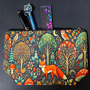 woodland fox canvas textured zip pouch featuring an orange fox surrounded by trees, owls, birds, butterflies , flowers and mushrooms in a richly detailed forest scene. Uk cute gifts shop.