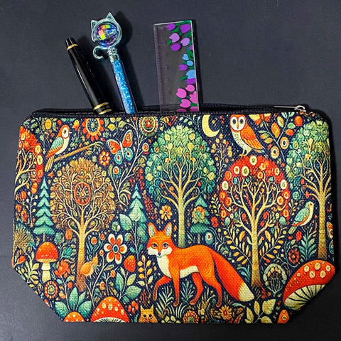 woodland fox canvas textured zip pouch featuring an orange fox surrounded by trees, owls, birds, butterflies , flowers and mushrooms in a richly detailed forest scene. Uk cute gifts shop.