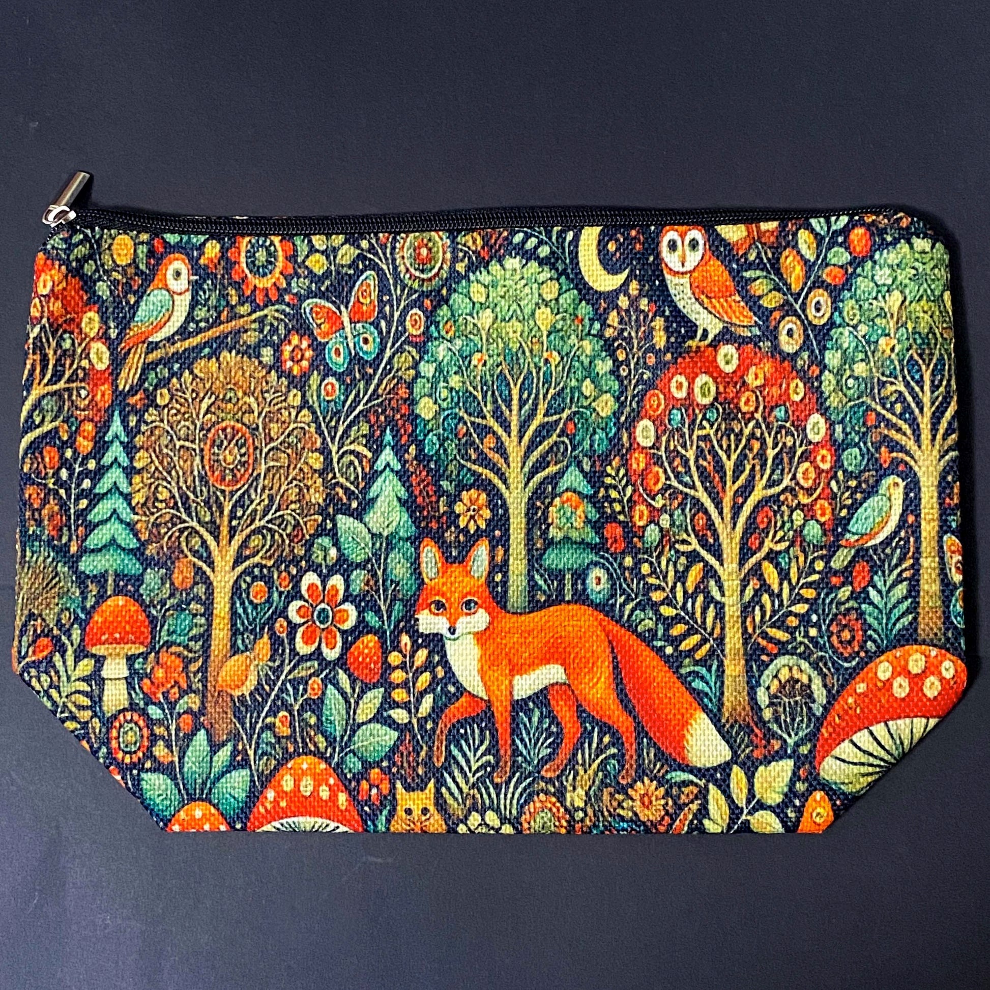 woodland fox canvas textured zip pouch featuring an orange fox surrounded by trees, owls, birds, butterflies , flowers and mushrooms in a richly detailed forest scene. Uk cute gifts shop.
