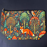 woodland fox canvas textured zip pouch featuring an orange fox surrounded by trees, owls, birds, butterflies , flowers and mushrooms in a richly detailed forest scene. Uk cute gifts shop.