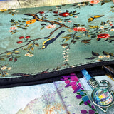 vintage botanical canvas cosmetic pouch featuring a song bird, flowers, butterflies and berries on a sage turquoise soft green blue background with black zip fastening. for journaling, scrapbooking and cosmetics. uk cute letterbox gifts shop.