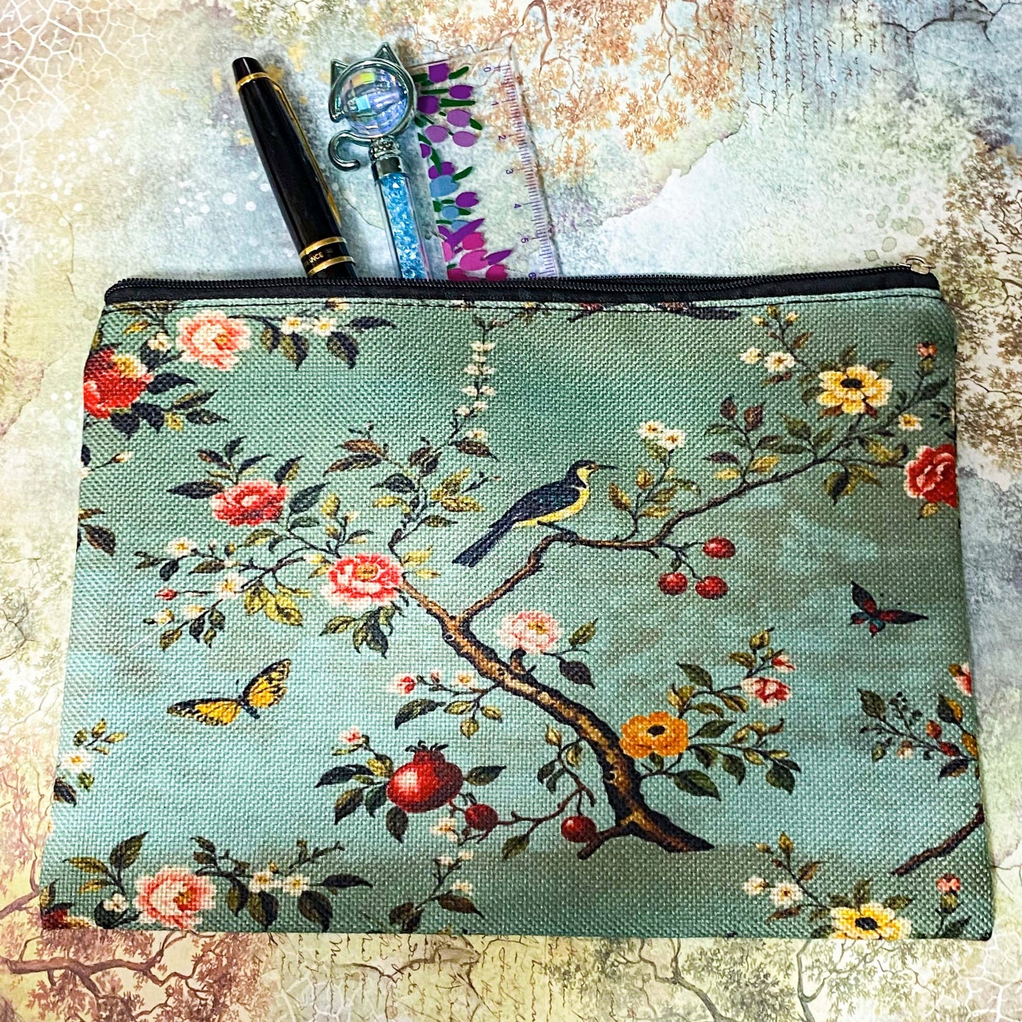 vintage botanical canvas cosmetic pouch featuring a song bird, flowers, butterflies and berries on a sage turquoise soft green blue background with black zip fastening. for journaling, scrapbooking and cosmetics. uk cute letterbox gifts shop.