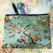 vintage botanical canvas cosmetic pouch featuring a song bird, flowers, butterflies and berries on a sage turquoise soft green blue background with black zip fastening. for journaling, scrapbooking and cosmetics. uk cute letterbox gifts shop.