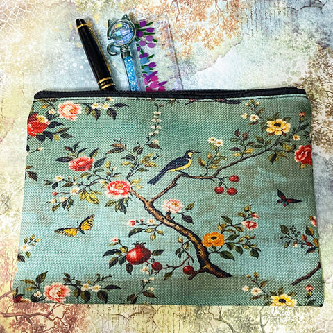 vintage botanical canvas cosmetic pouch featuring a song bird, flowers, butterflies and berries on a sage turquoise soft green blue background with black zip fastening. for journaling, scrapbooking and cosmetics. uk cute letterbox gifts shop.
