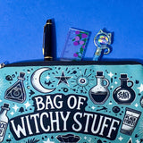 turquoise and black canvas zip pouch featuring the words "Bag of witchy stuff" surrounded by potion bottles, moons, stars, crystals and magical symbols. Uk cute and kawaii gifts shop. Bag for journaling, crystal storage or witchcraft supplies.