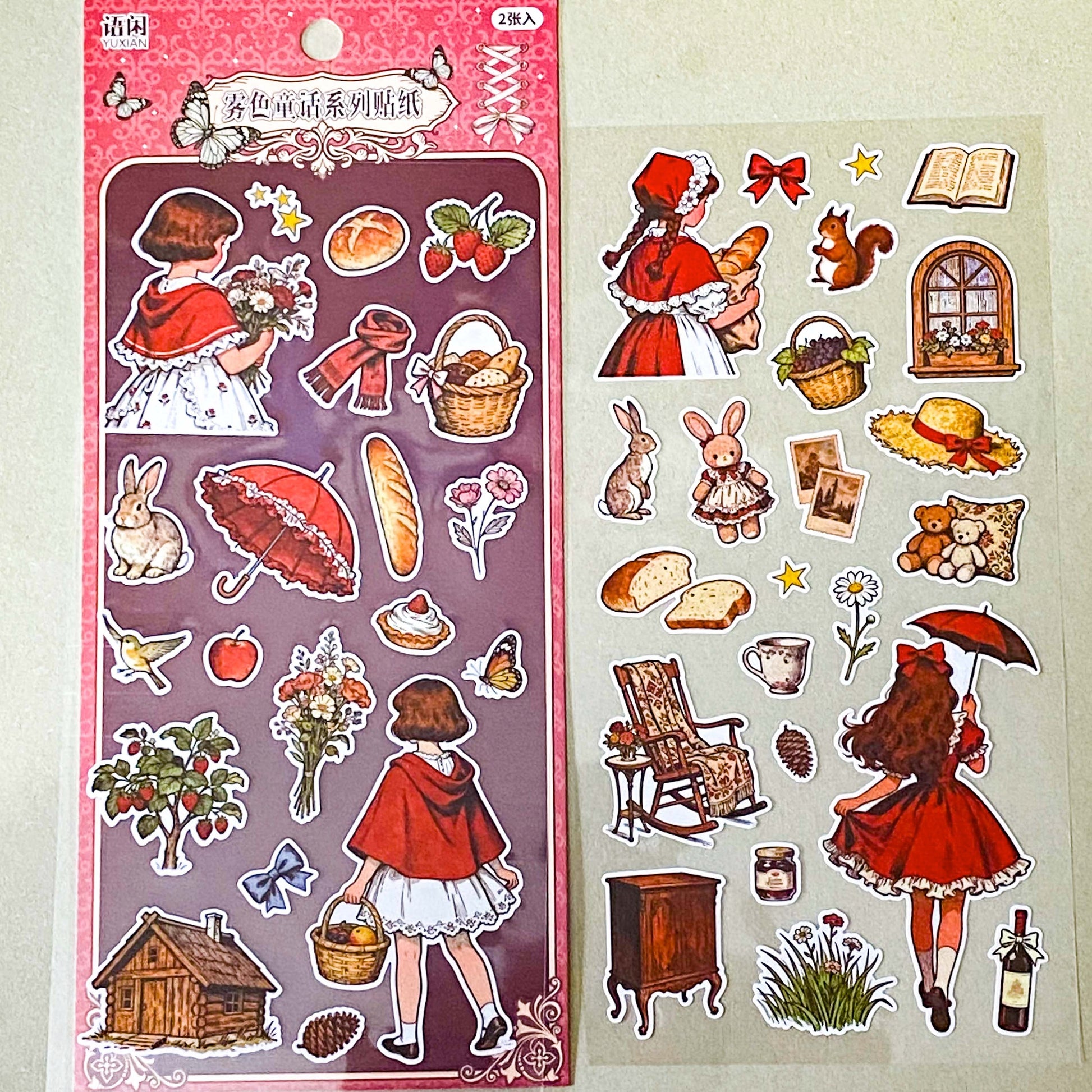 red riding hood's cottage matte sticker pack with two decorative clear sheets of stickers featuring little red riding hood, woodland animals, cottages, flowers, baskets, books, strawberries, squirrels, rabbits and cosy cottagecore illustrations.
