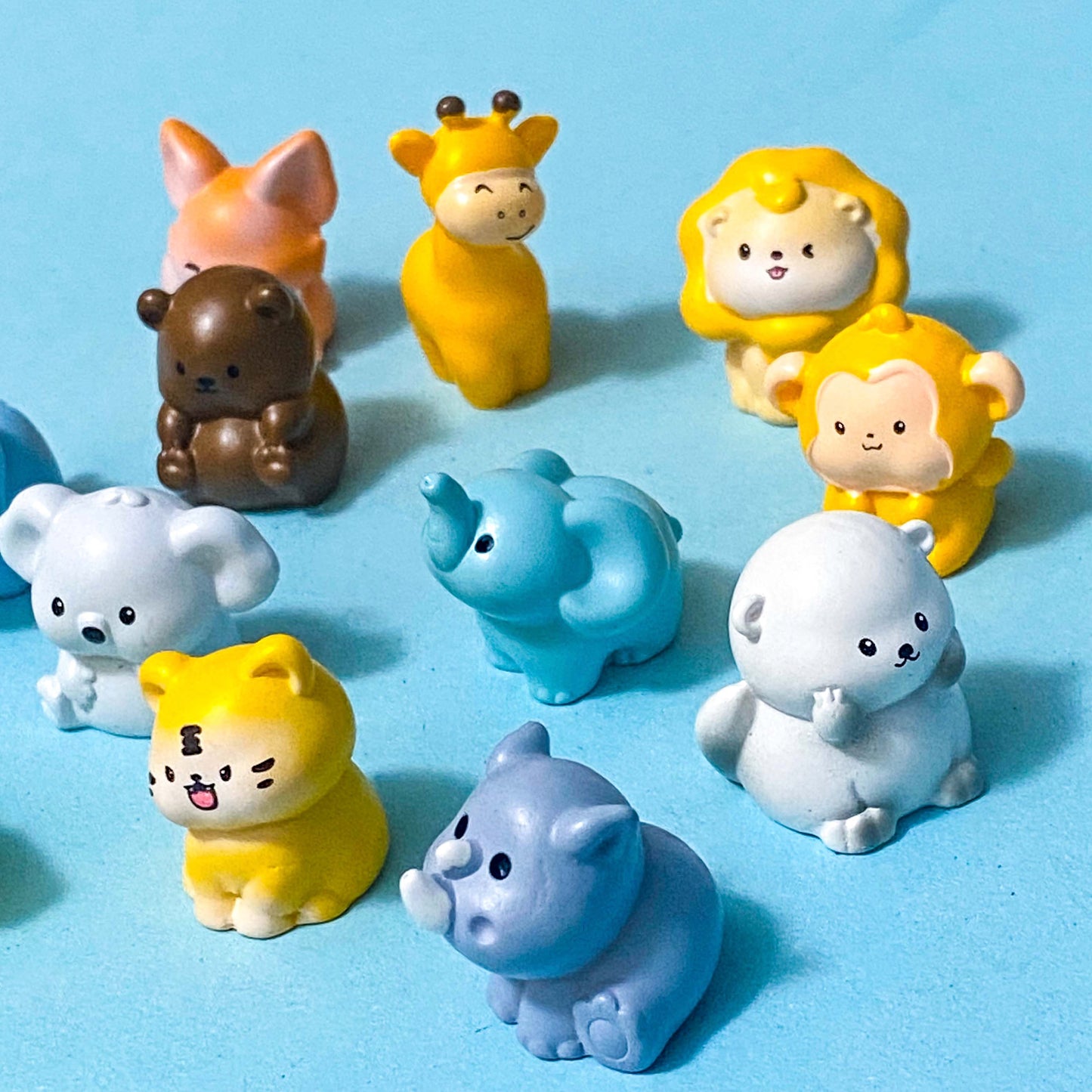 Set of wild and zoo animal figurines on a blue background