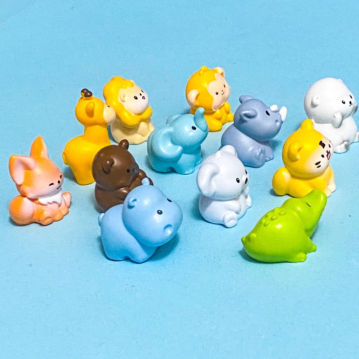 Set of colorful animal figurines on a blue background