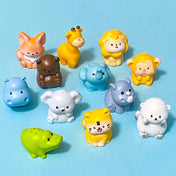 Set of colourful wild animal resin figurines on a blue background