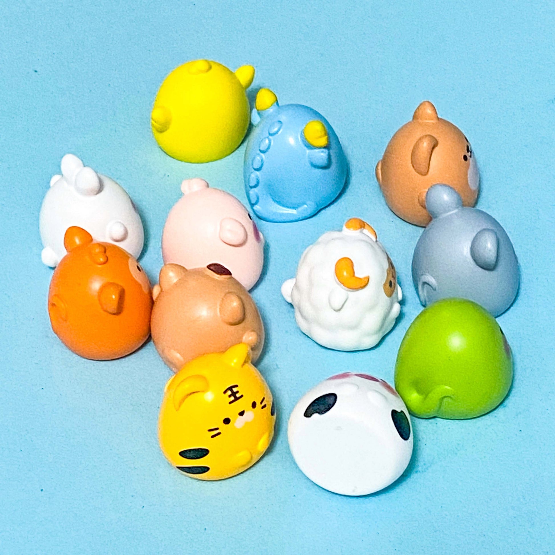 Chinese zodiac animal resin figurines on a blue background