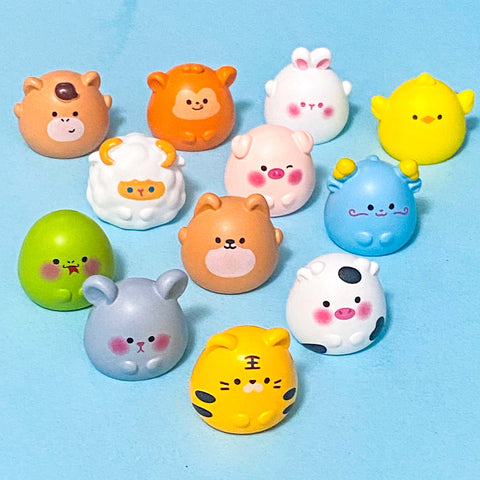 animal signs of the chinese zodiac cute resin figurines on a blue background