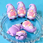 pastel lilac gnome silicone bead with a pretty pink butterfly pattern on a blue background