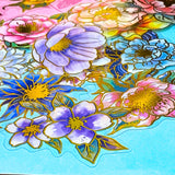 assorted large gold foil floral stickers on a turquoise background