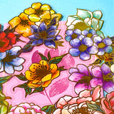 assorted large gold foil floral stickers on a turquoise and pink background