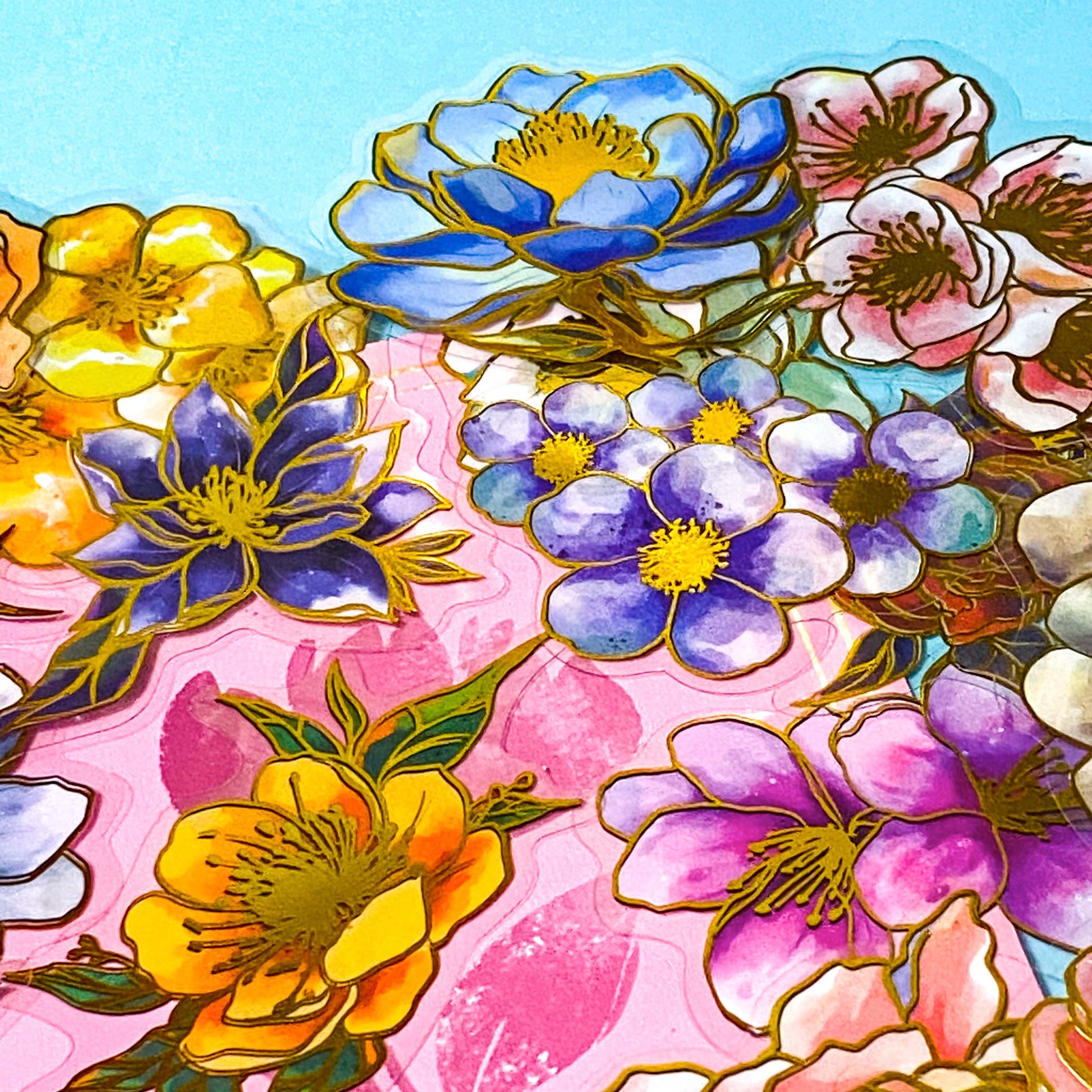 assorted large gold foil floral stickers on a turquoise and pink background