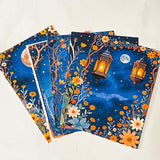 midnight garden scrapbook papers with moon, lantern and floral night sky designs arranged in fan layout