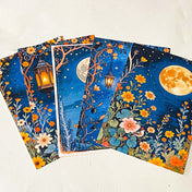midnight garden scrapbook papers with moon, lantern and floral night sky designs arranged in fan layout