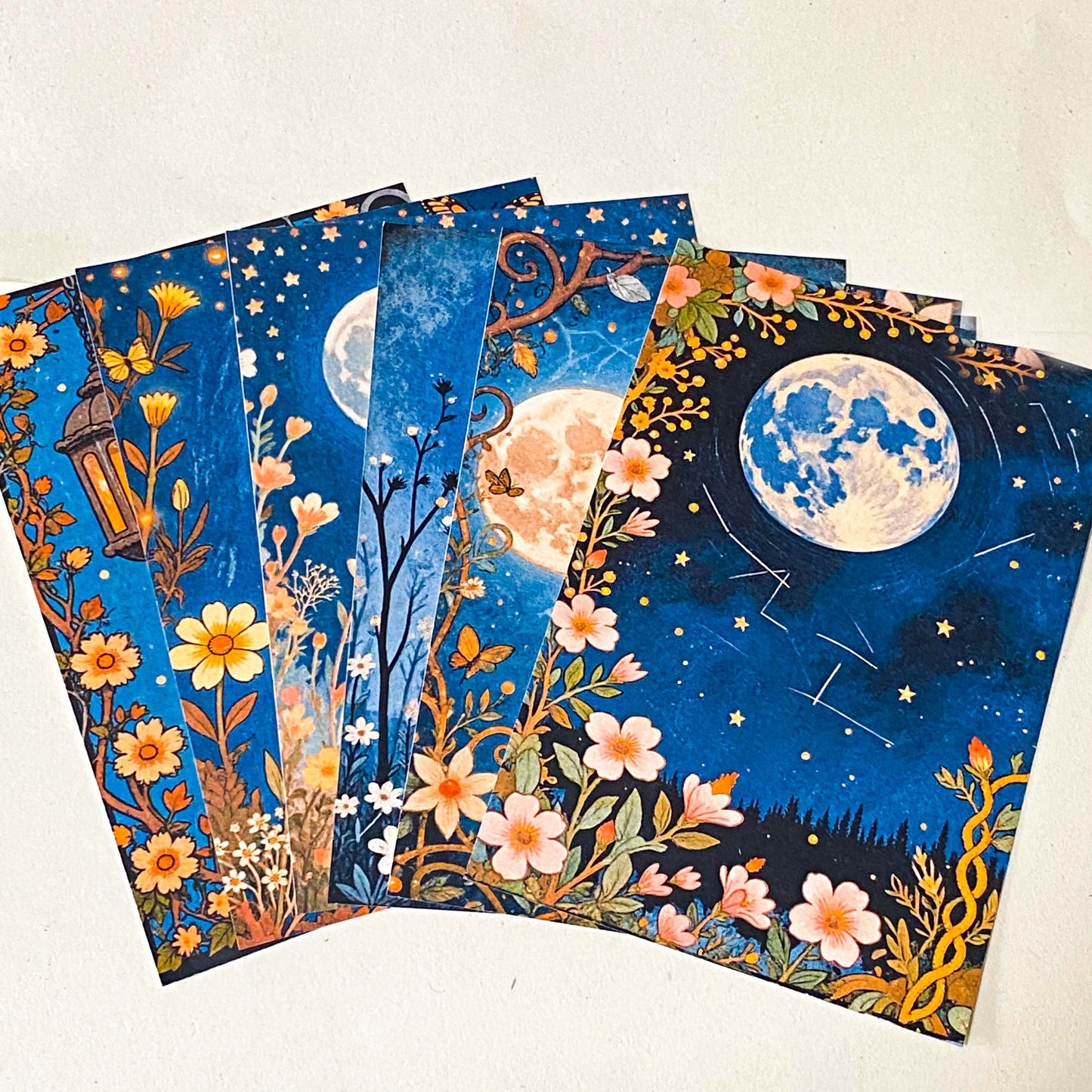 midnight garden scrapbook papers with moon, lantern and floral night sky designs arranged in fan layout