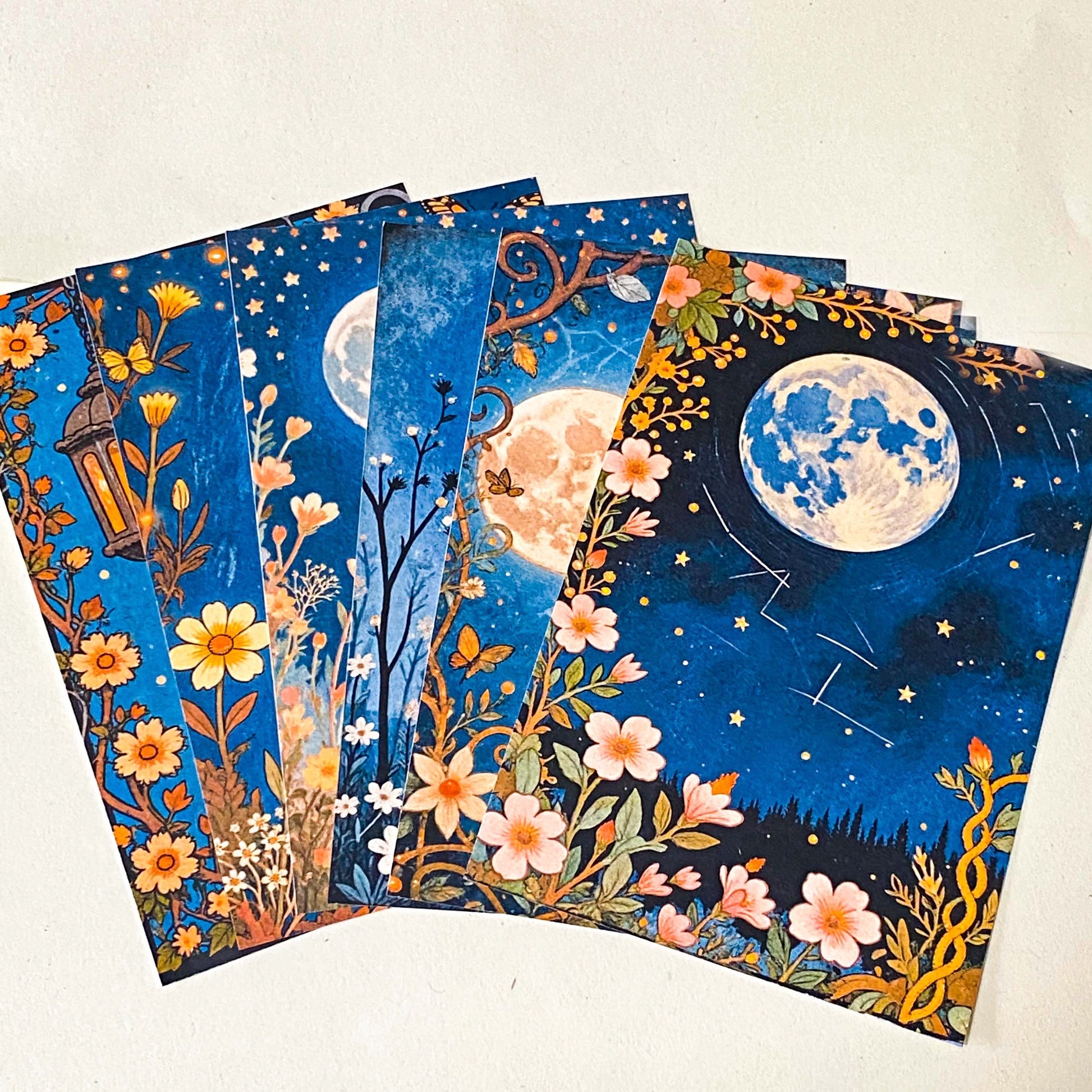 midnight garden scrapbook papers with moon, lantern and floral night sky designs arranged in fan layout