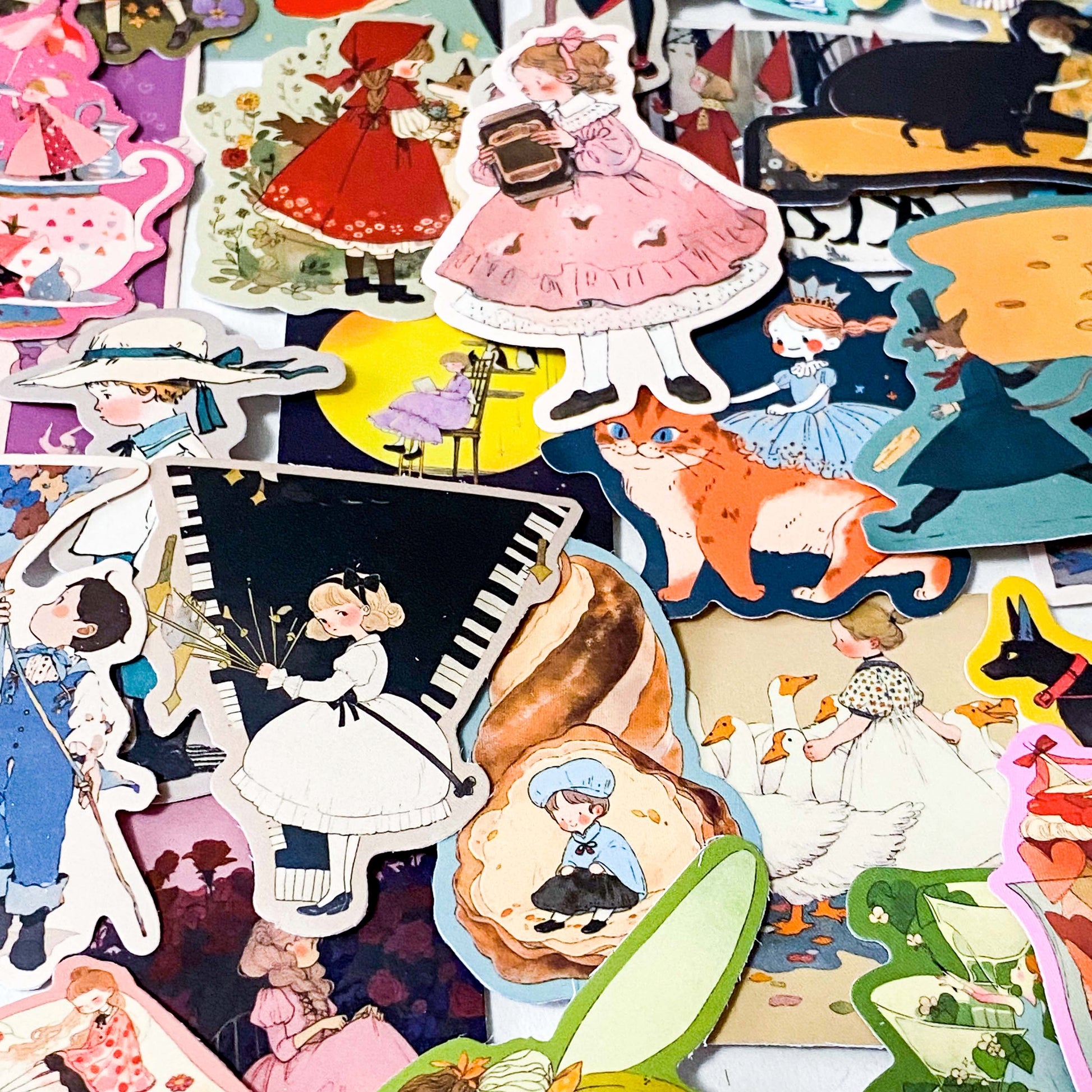 set of 50 vintage storybook style matte stickers featuring children, whimsical animals, cats and illustrated scenes in soft pastel and jewel tones for laptops and journaling