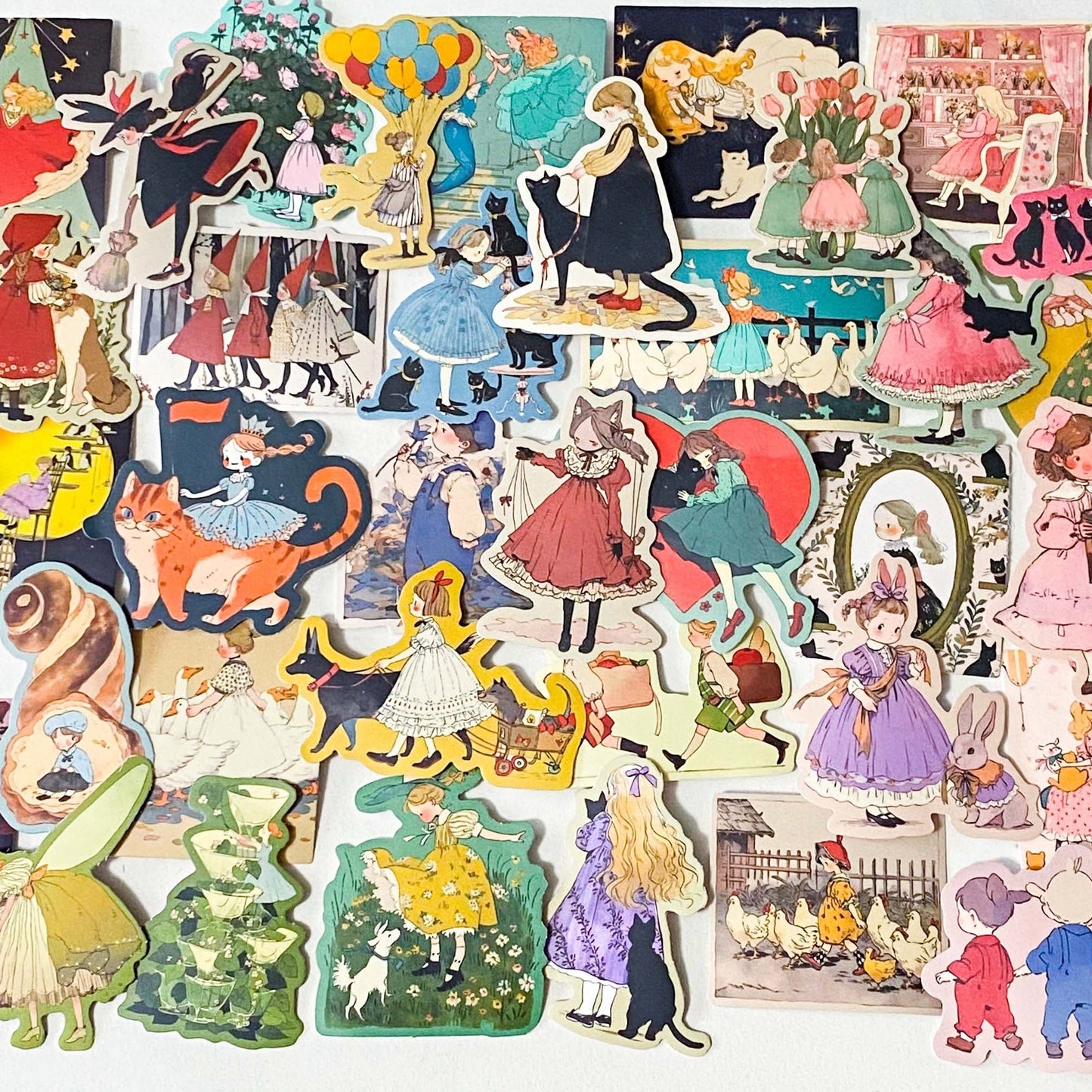 set of 50 vintage storybook style matte stickers featuring children, whimsical animals, cats and illustrated scenes in soft pastel and jewel tones for laptops and journaling