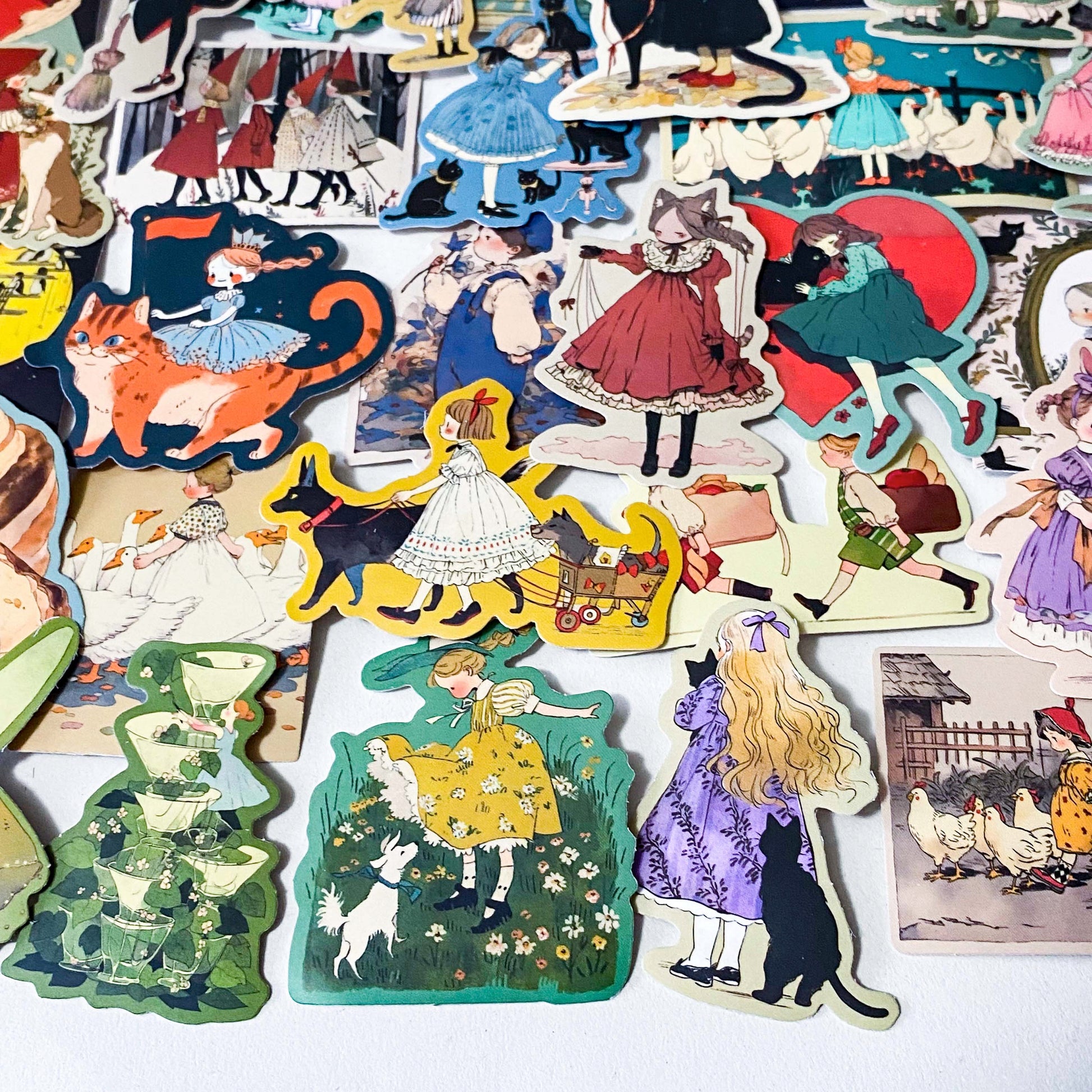 set of 50 vintage storybook style matte stickers featuring children, whimsical animals, cats and illustrated scenes in soft pastel and jewel tones for laptops and journaling