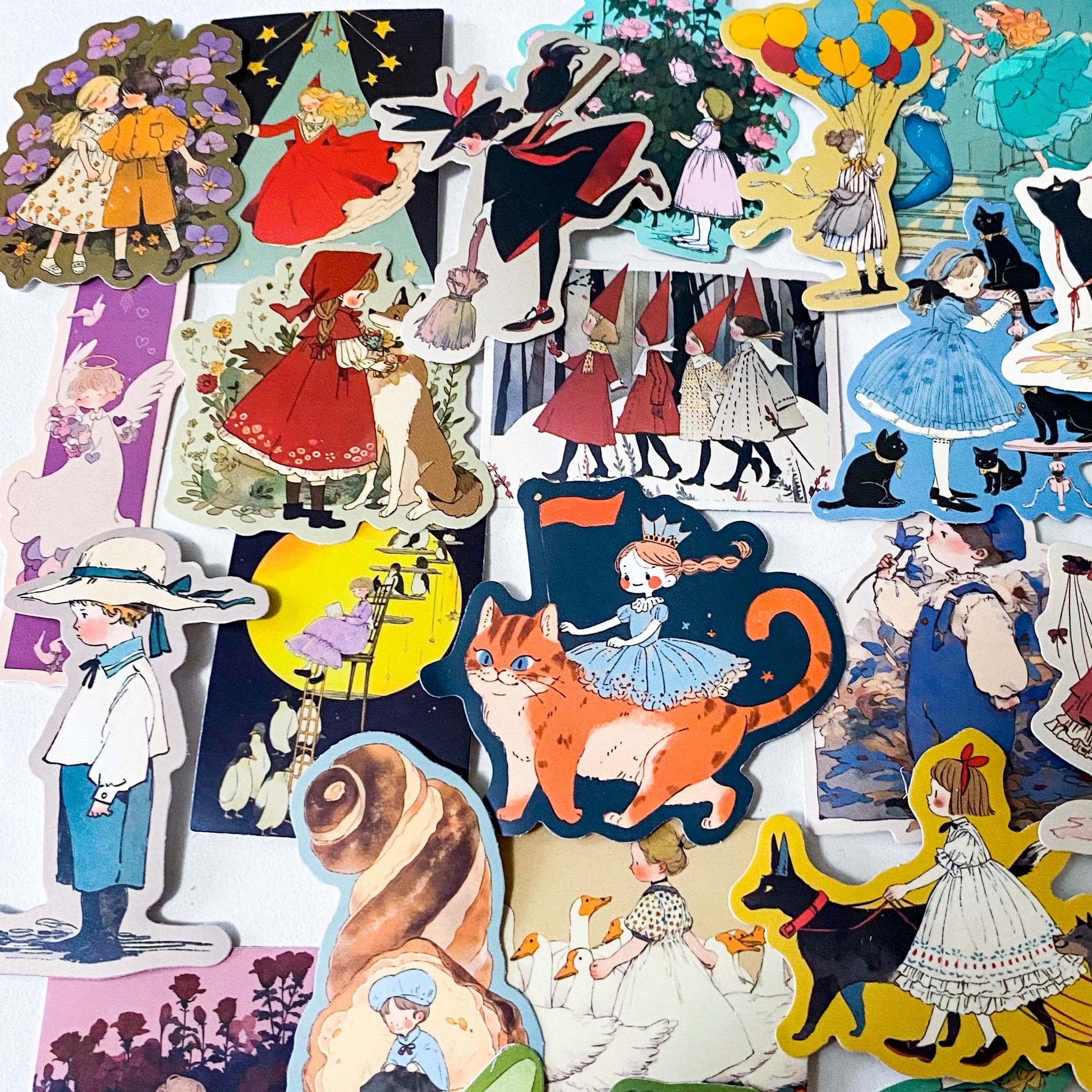 set of 50 vintage storybook style matte stickers featuring children, whimsical animals, cats and illustrated scenes in soft pastel and jewel tones for laptops and journaling