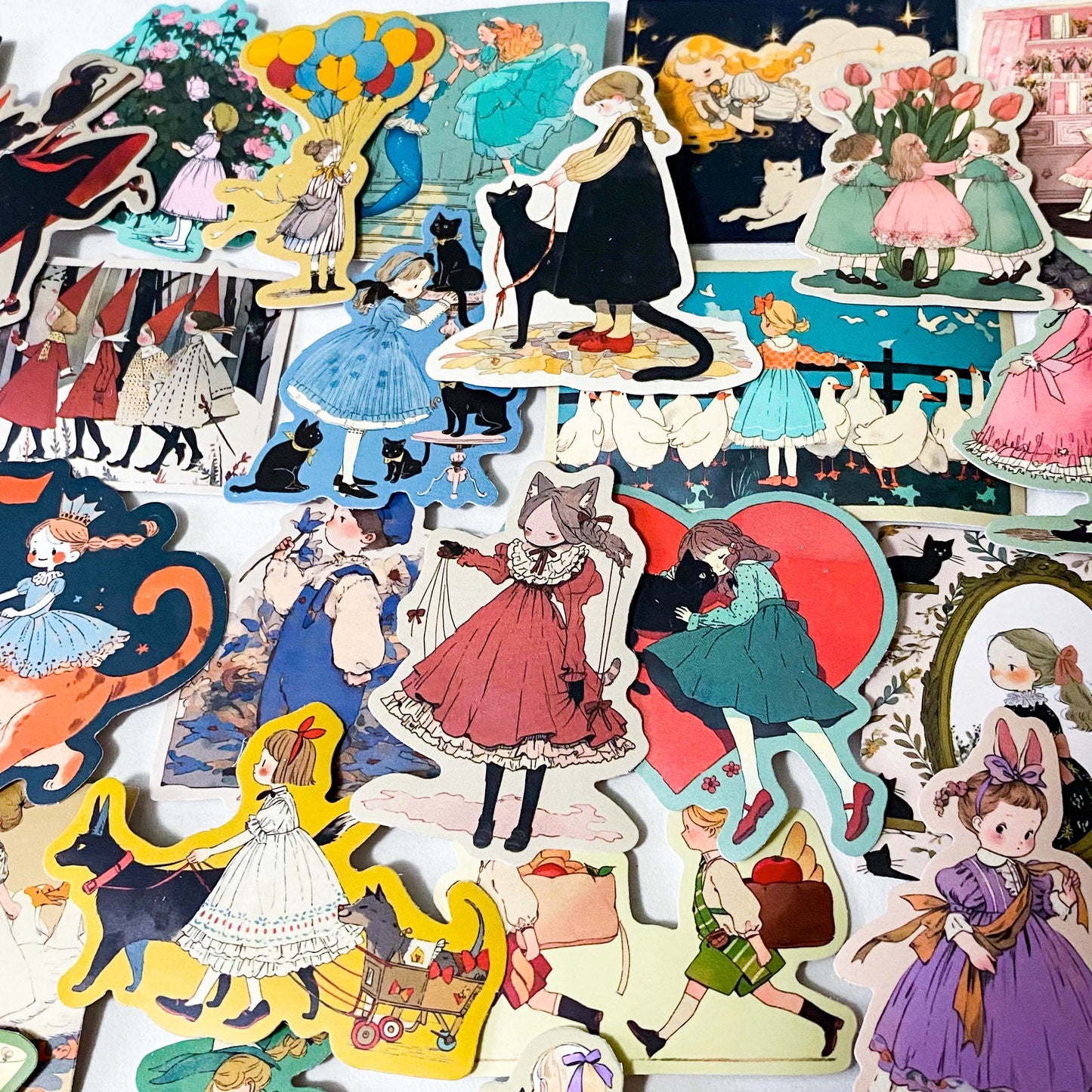 set of 50 vintage storybook style matte stickers featuring children, whimsical animals, cats and illustrated scenes in soft pastel and jewel tones for laptops and journaling