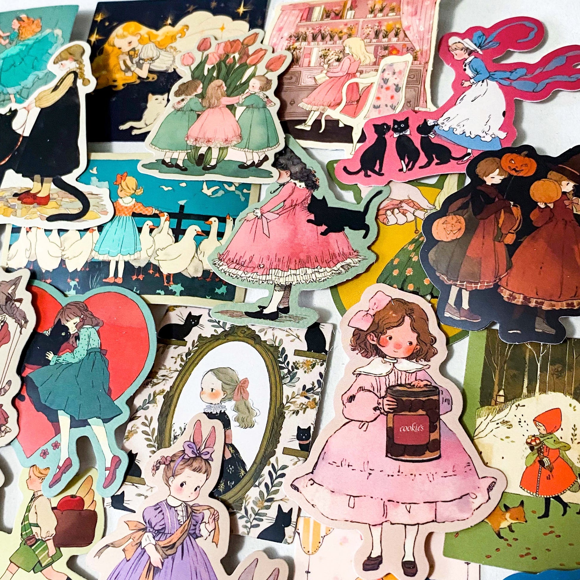 set of 50 vintage storybook style matte stickers featuring children, whimsical animals, cats and illustrated scenes in soft pastel and jewel tones for laptops and journaling