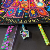 black and vibrant colours canvas tarot pouch featuring colourful tarot cards, crystal balls, candles, stars and moon and mystical symbols. Uk letterbox gifts shop.