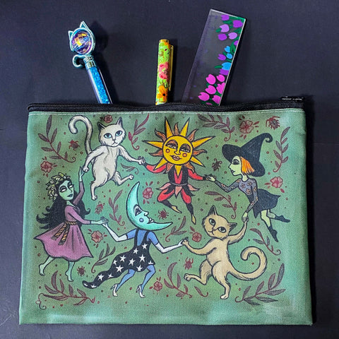 whimsical green blue zipper pouch featuring dancing cats, sun and moon characters, folk art inspired fairytale figures. witchy pencil case or journaling pouch. uk cute kawaii gifts shop.