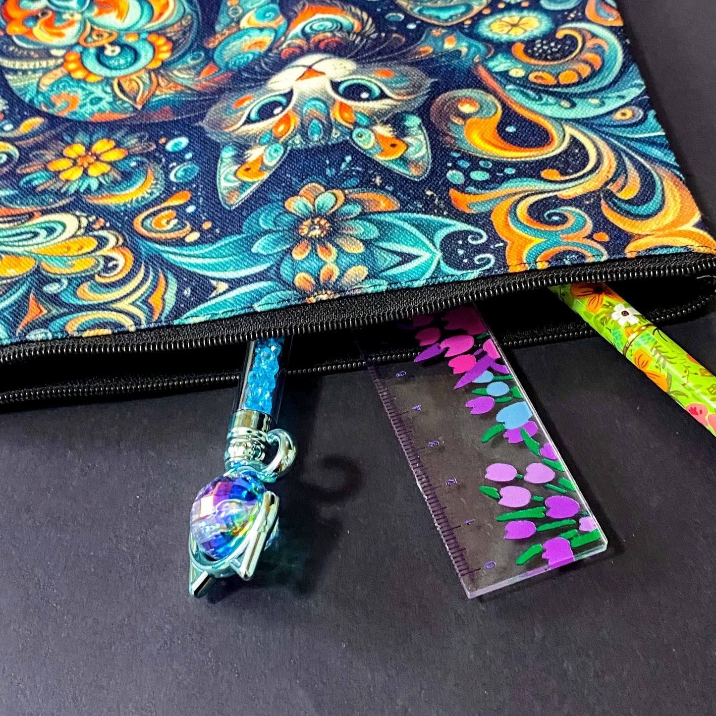 decorative folk art cat zipper canvas pouch featuring bright turquoise, navy and orange swirling floral patterns on a dark blue background. uk cute magical letterbox gifts shop. 