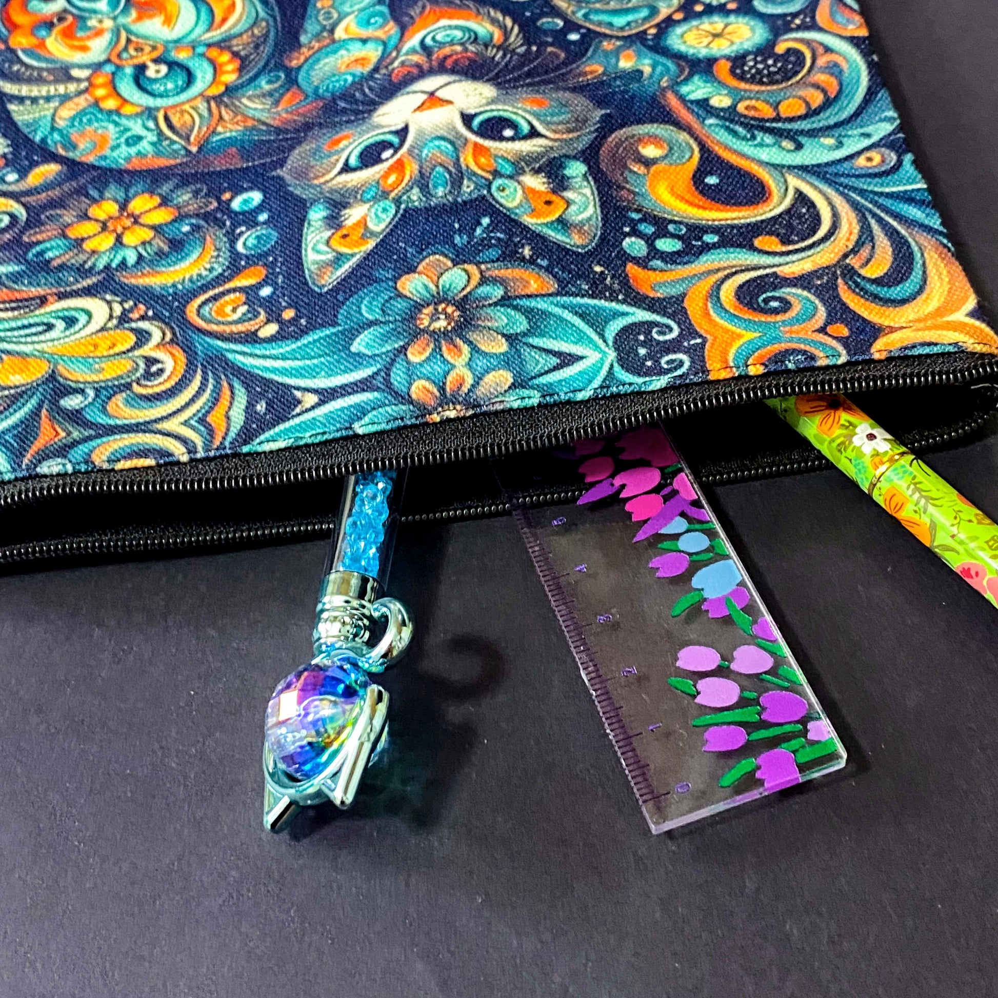 decorative folk art cat zipper canvas pouch featuring bright turquoise, navy and orange swirling floral patterns on a dark blue background. uk cute magical letterbox gifts shop. 